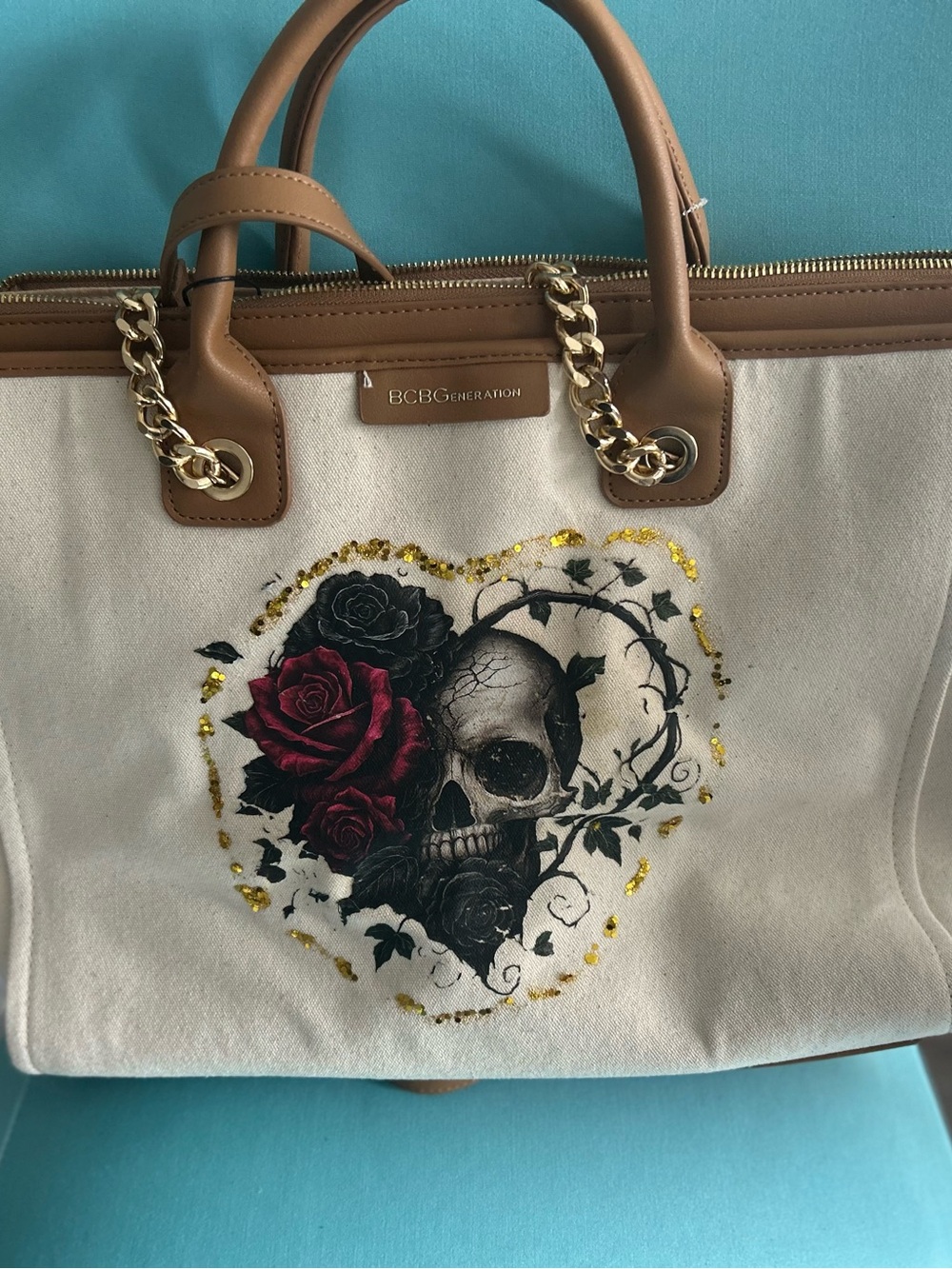 BCBGeneration Beige Canvas Tote with Brown Trim and Red Rose Skull Graphic